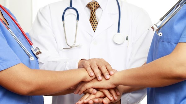 medical professionals stacking hands