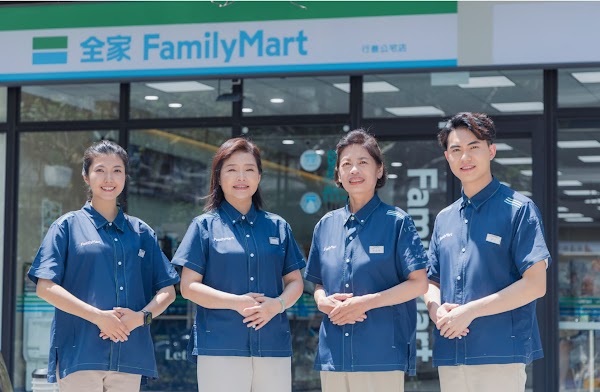 FamilyMart representatives standing in front of the store