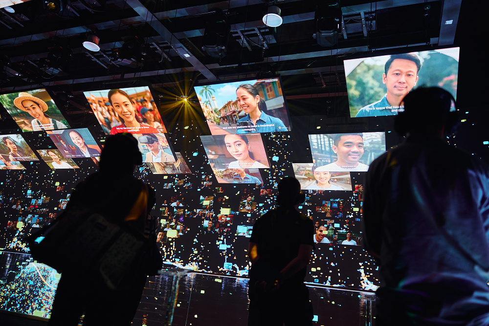 An exhibition where multiple screens or projections cover a large wall