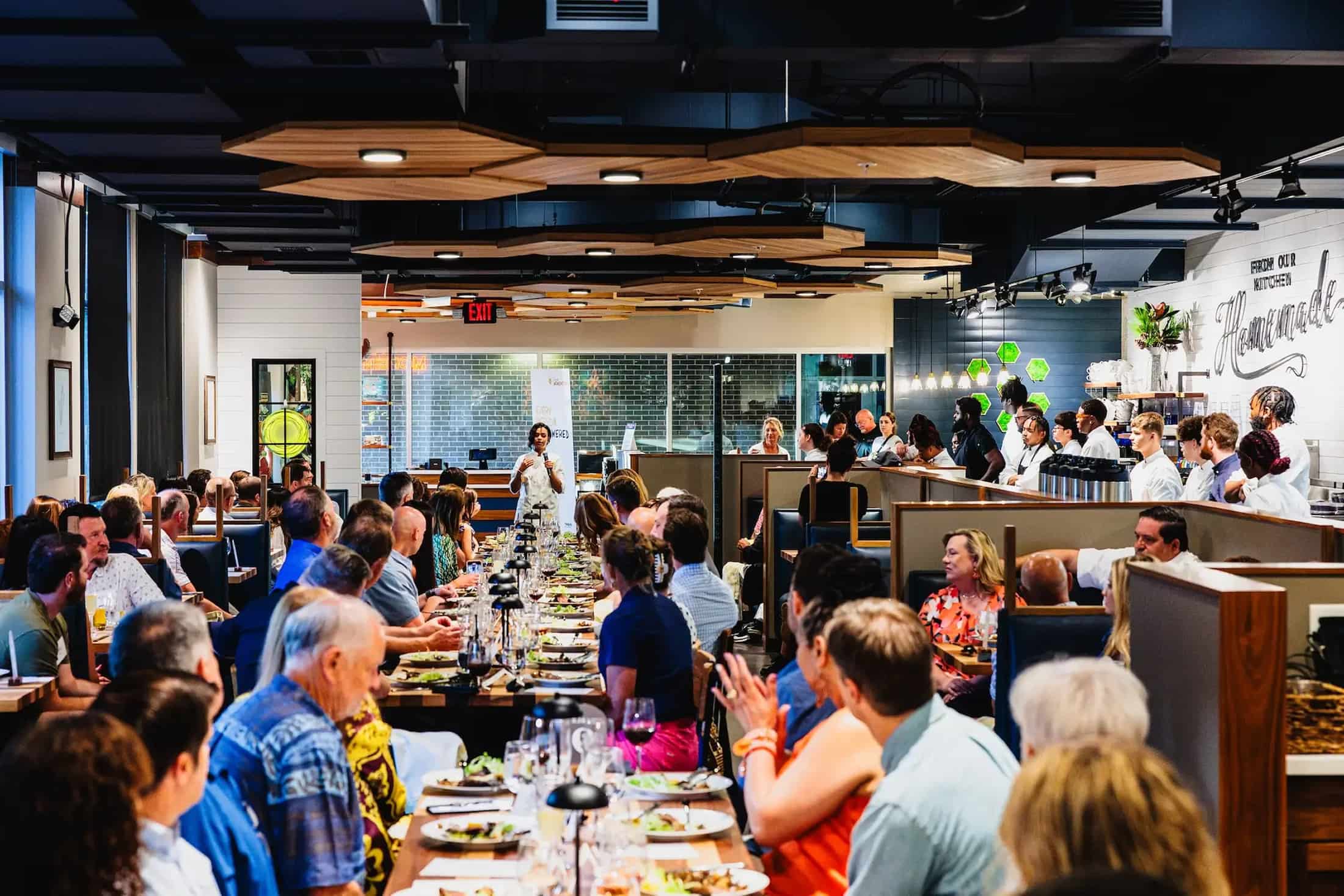 Wide view of a busy restaurant dining room during an event