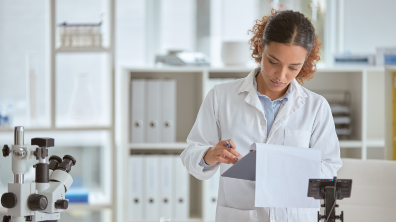 woman conducting research and reviewing paperwork