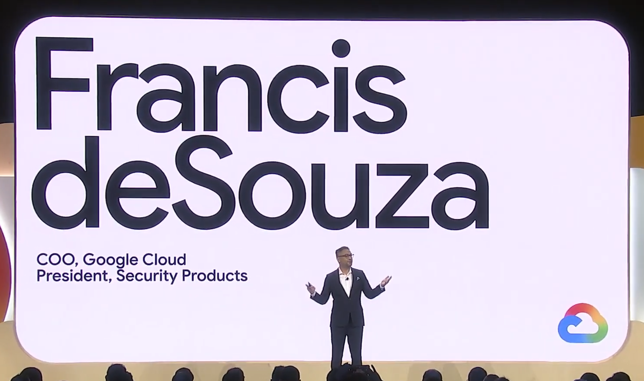 Francis deSouza presenting on a Google Cloud stage