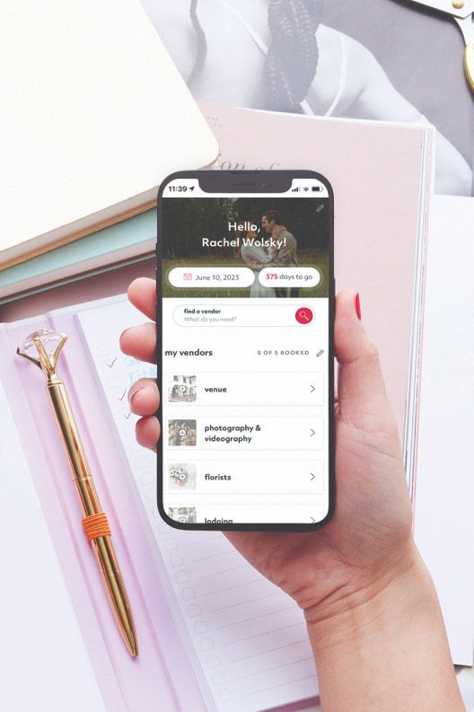 A hand holding a smartphone with VendorConnect app open on it