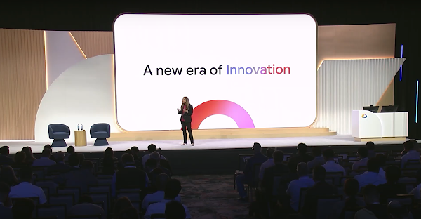 Woman on stage with presentation and full audience