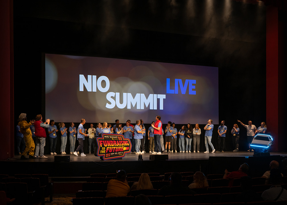 NIO SUMMIT LIVE event stage with group of attendees