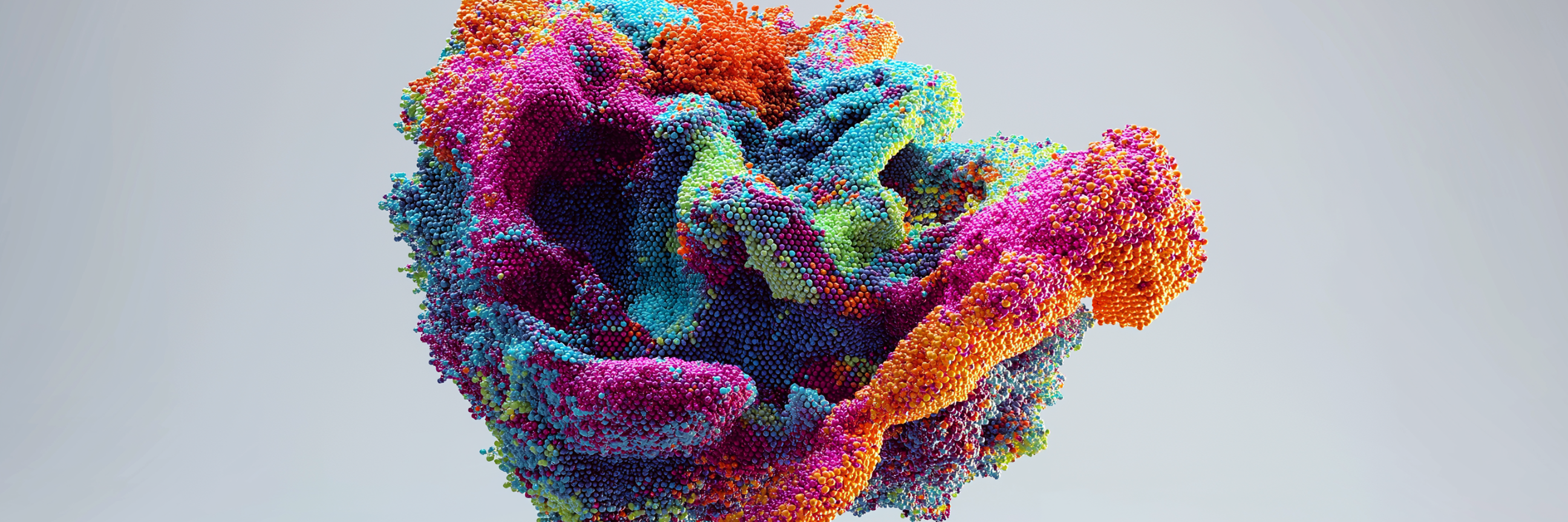 An abstract 3D formation made of densely packed, colorful spheres in shades of pink, blue, and orange against a plain background.