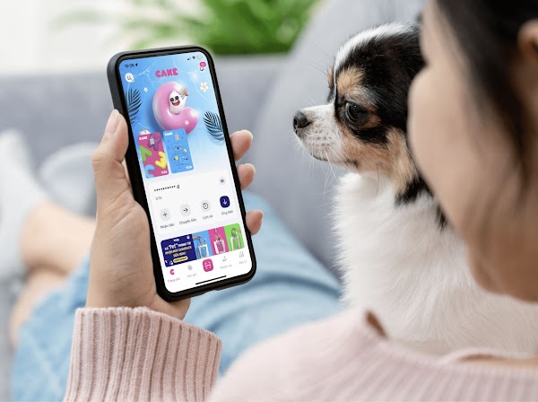 Lady with a dog viewing the Cake Digital Bank mobile app