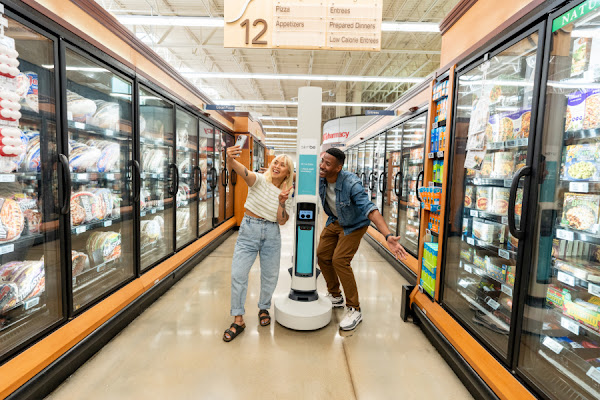 A male and female shopper user Simbe to track their products in the supermarket