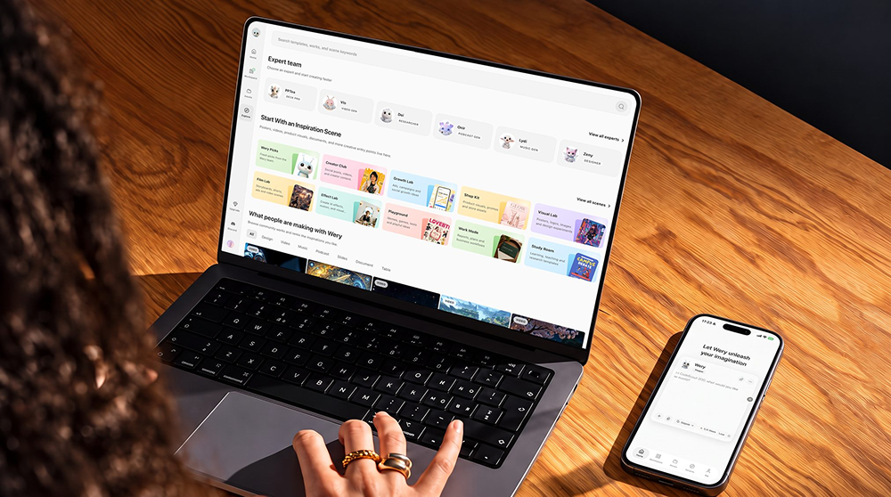 Apple MacBook laptop and an iPhone on a wooden desk