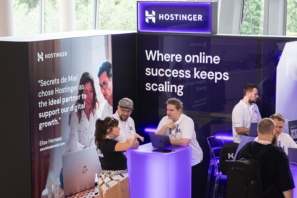 Hostinger booth with the slogan "Where online success keeps scaling"