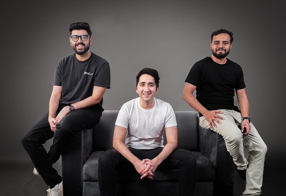 Three men in t-shirts posing on a gray couch: Jurisphere founders