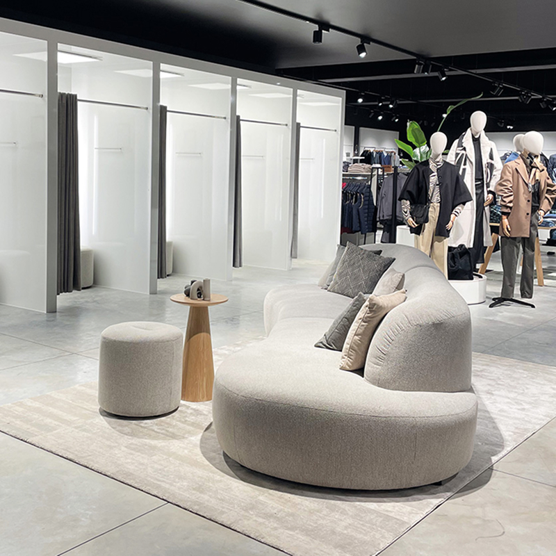 Curved sofa seating area near fitting rooms in e5 store