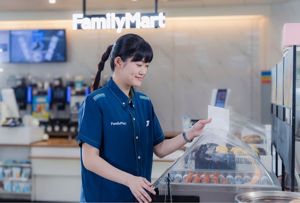 FamilyMart representative at the cash counter