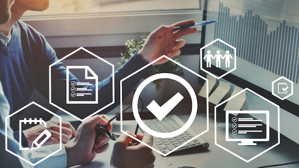 two people reviewing a bar chart with holographic icons layered throughout