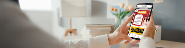 A hand holding a smartphone with Shop Global app on it