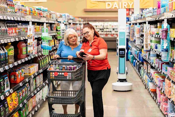 Lady assistant helping an elderly lady locate products 