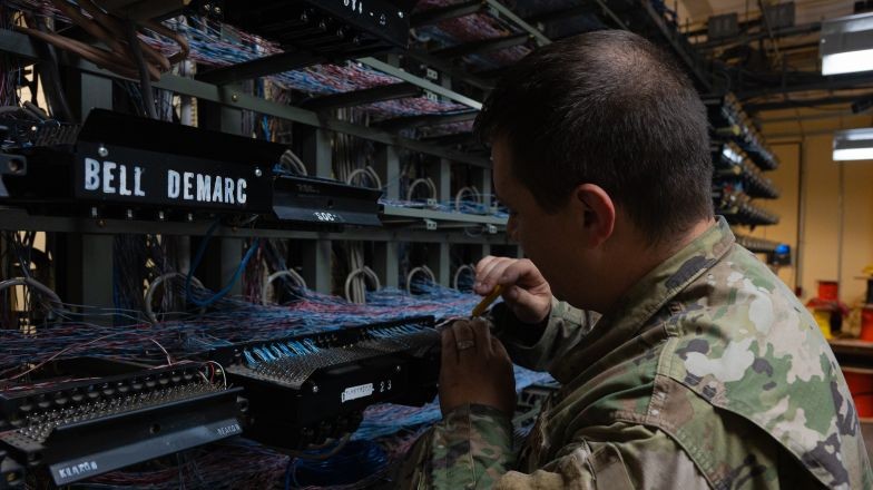 service person working with many wires and devices