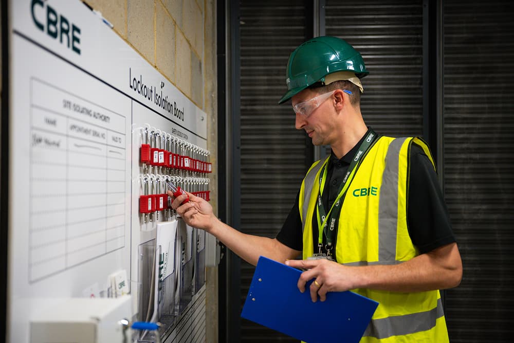 A CBRE representative standing across a Lockout Isolation Board