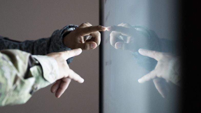 Two hands pointing at a screen