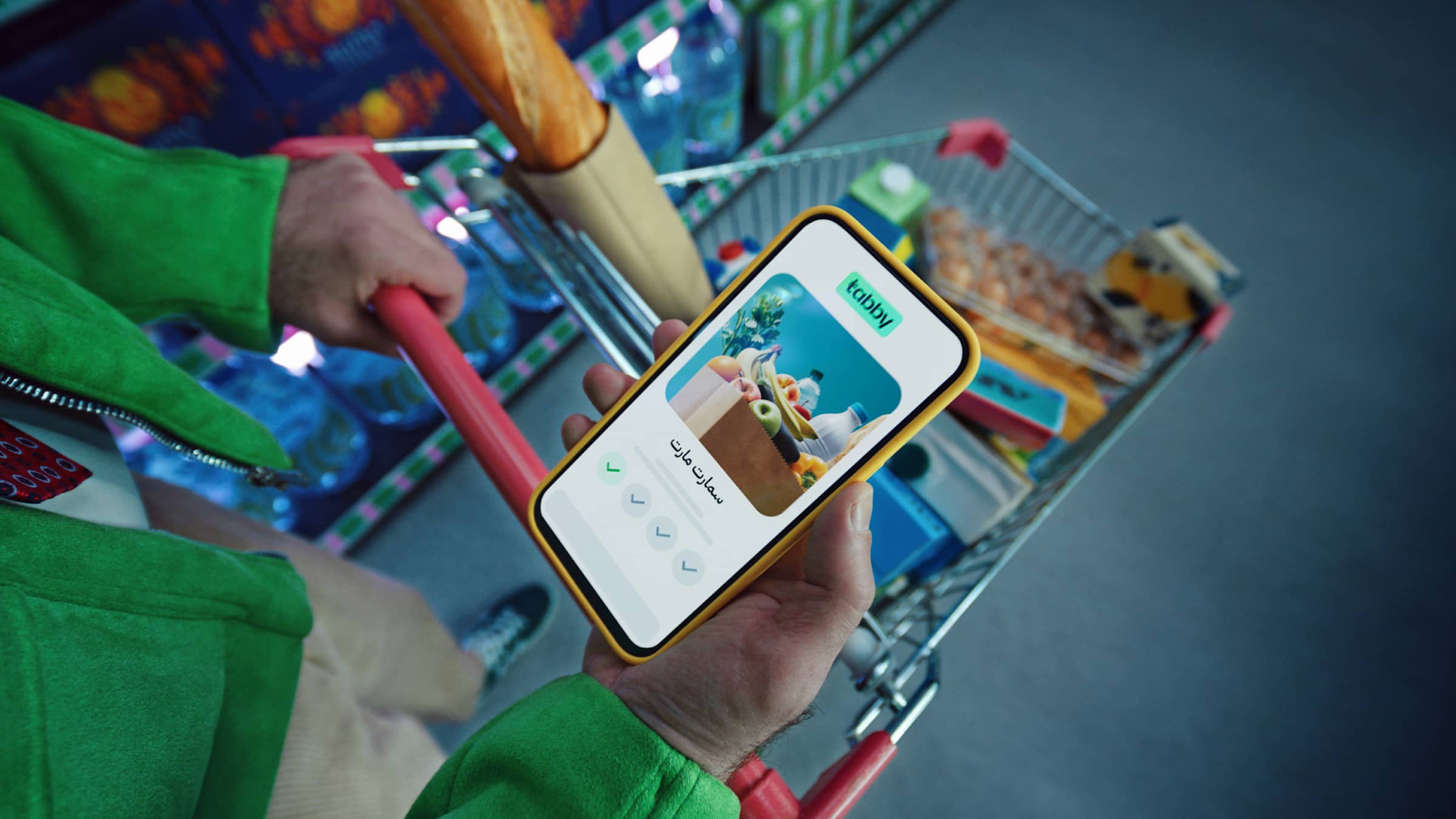 A hand holding a smartphone with Tabby app open on it