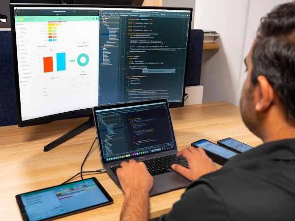 Maulik Patel, MyVenue Lead Software Developer, in back office and code on screen