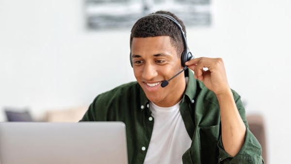 man with headset using laptop
