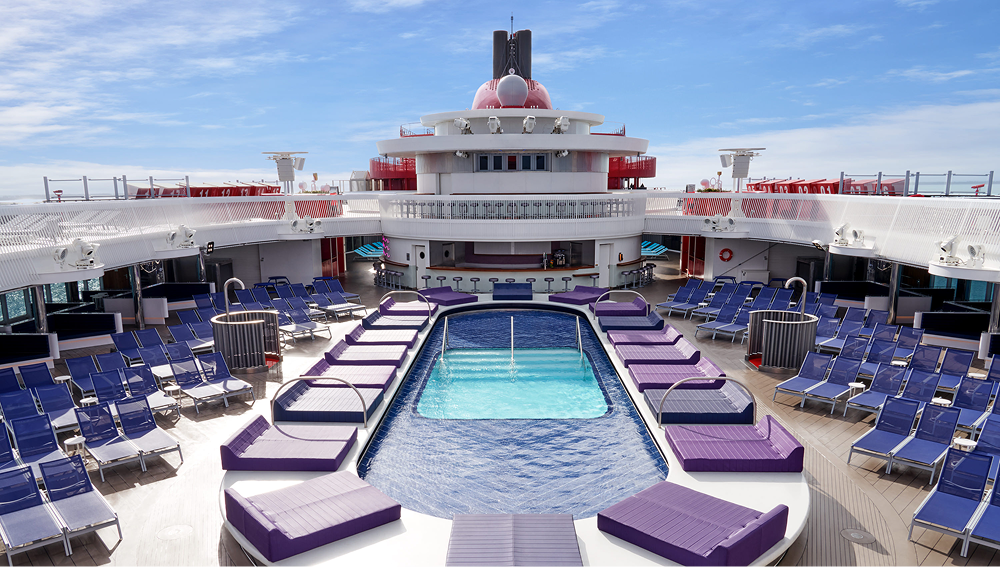 Cruise ship deck with a swimming pool and purple daybeds