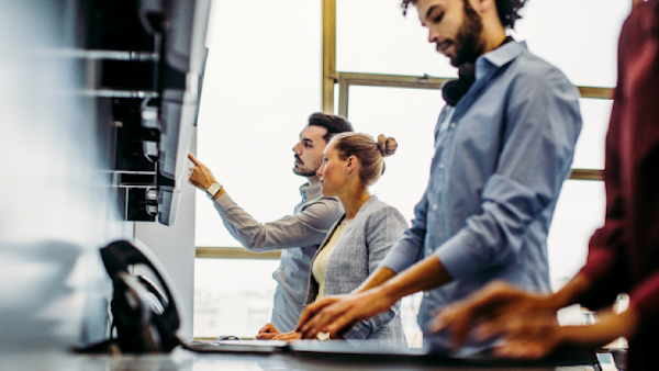 two males behind computer screen