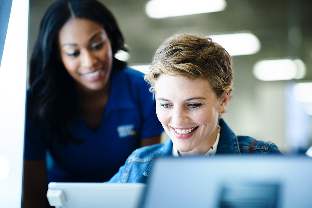 Two women looking at a computer screen