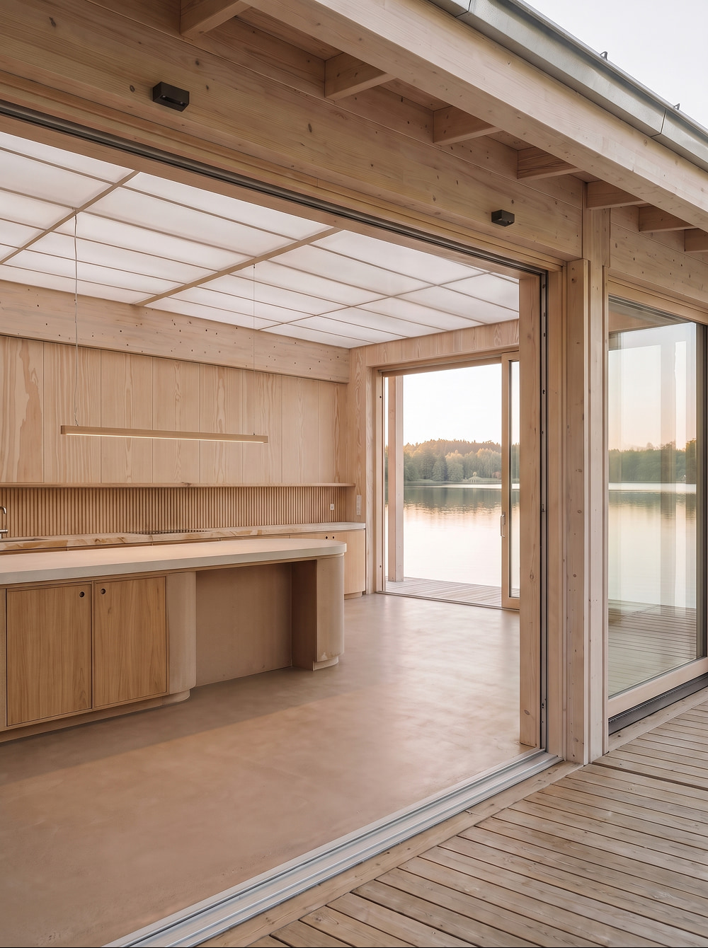 A modern, wooden lakeside cabin with a minimalist kitchen 