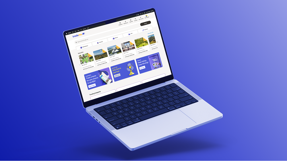 A laptop shows the Trade Me website with marketplace, property, and car listings against a vibrant purple background.