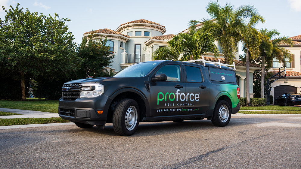 Proforce Pest Control branded service vehicle parked in a residential neighborhood