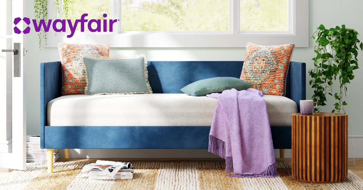 Wayfair furniture set with blue sofa and patterned pillows.