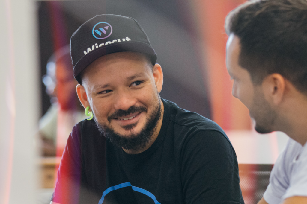 A man wearing a black cap and t-shirt during a conversation