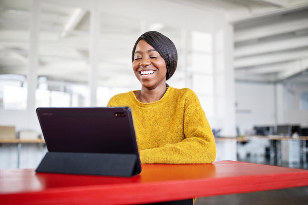 Girl in yellow sweater at laptop