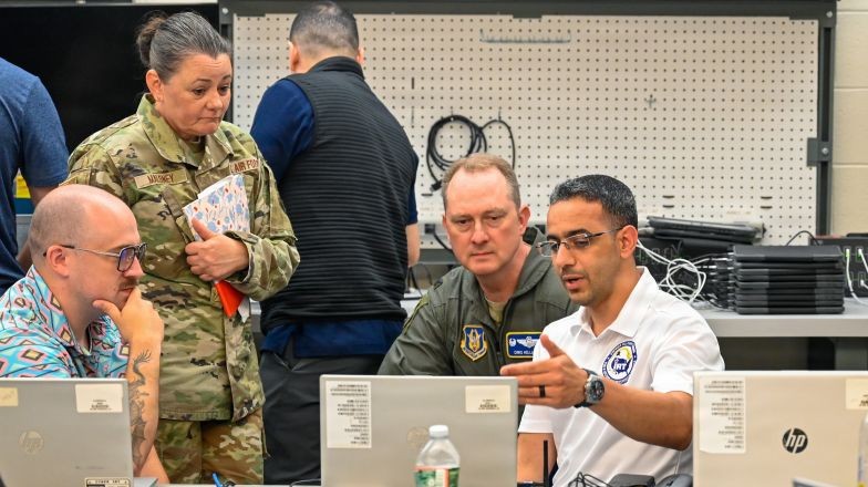 People reviewing code across multiple devices