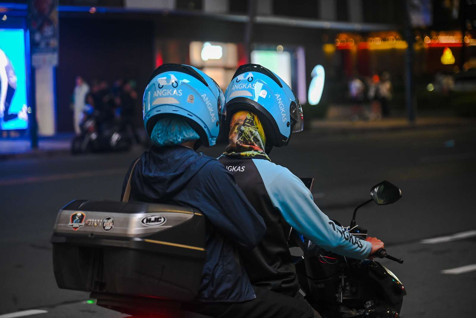 An Angkas driver taking his customer to his destination