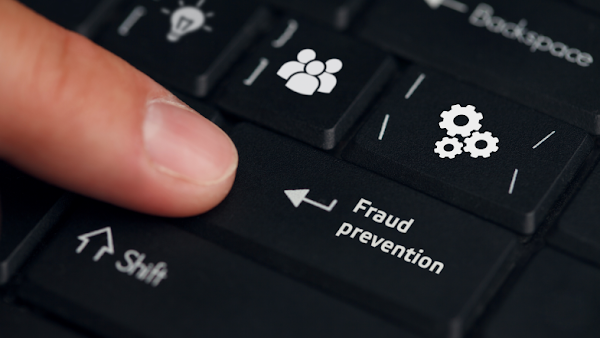 finger kicking key on keyboard labeled fraud prevention