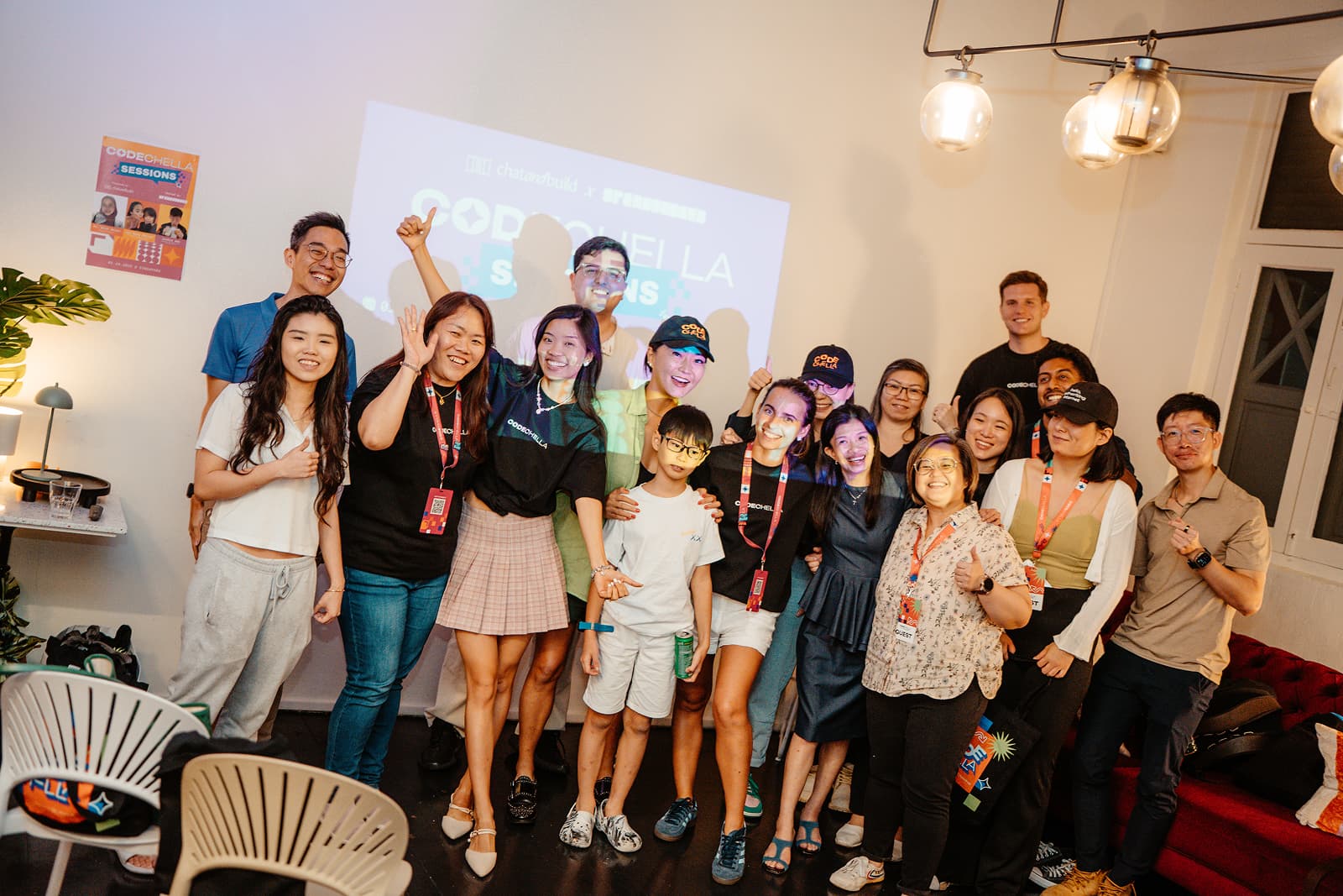 Group of children and women with a projector screen in the background
