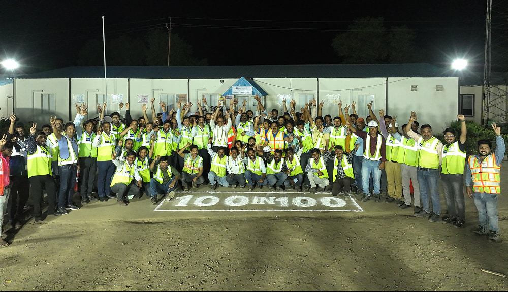 Team celebrating 100 kms lane completion