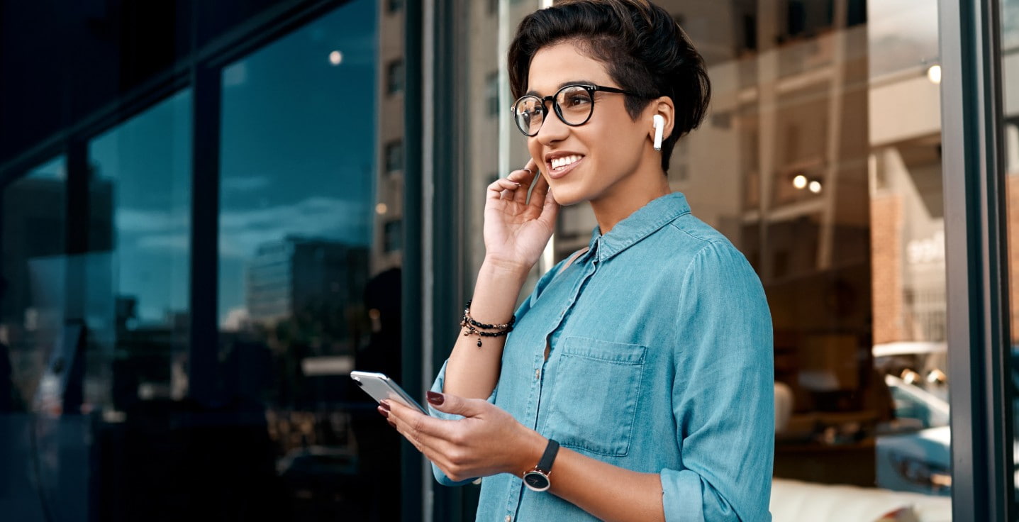 Woman listening on mobile earbuds