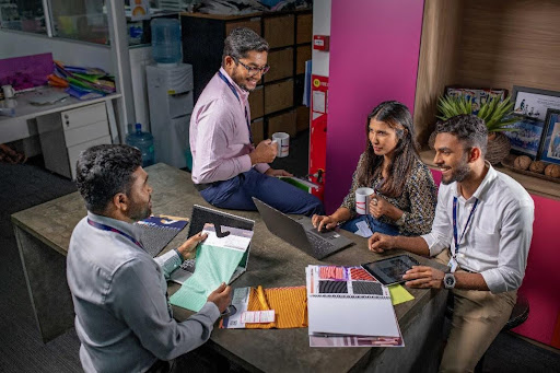 A group of men chatting on shop floor