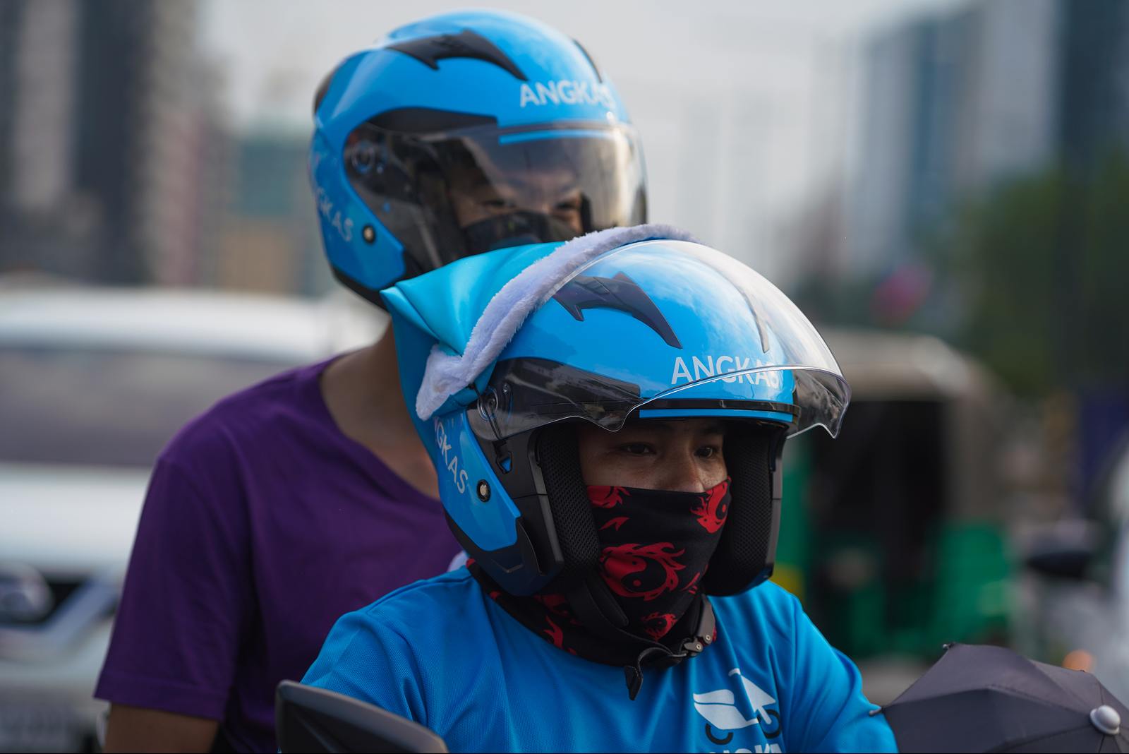 An Angkas driver taking his customer to his destination