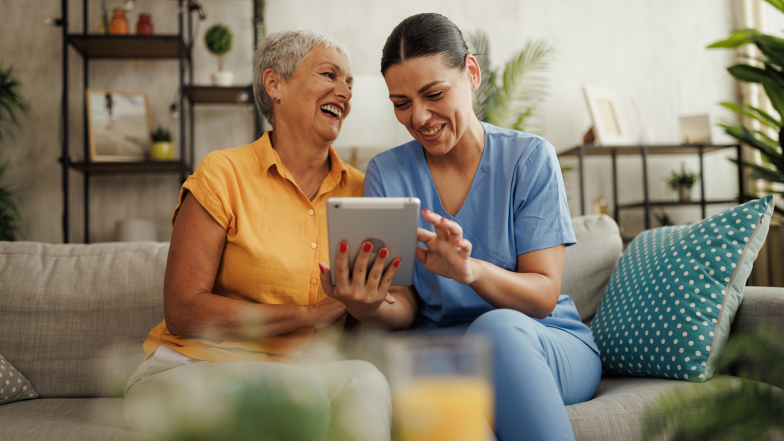 nurse works with senior citizen on digital care