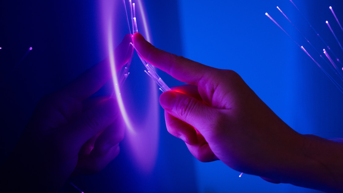 hand touching fiber optics