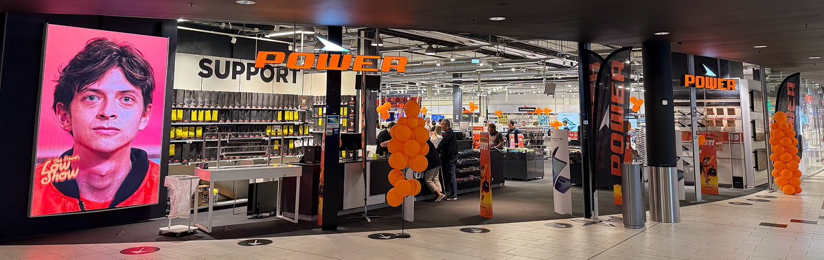 Electronics store entrance with "POWER" sign
