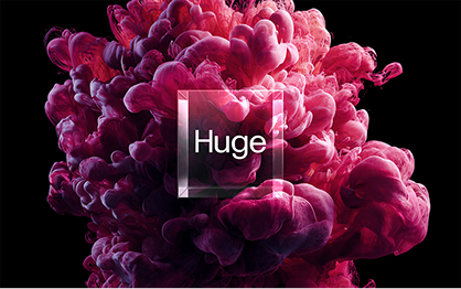 A cube with the word "Huge" over pink and red smoke