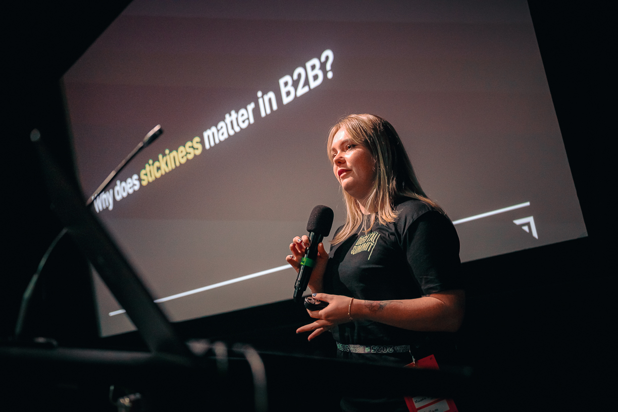 A woman speaking at a podium during a presentation