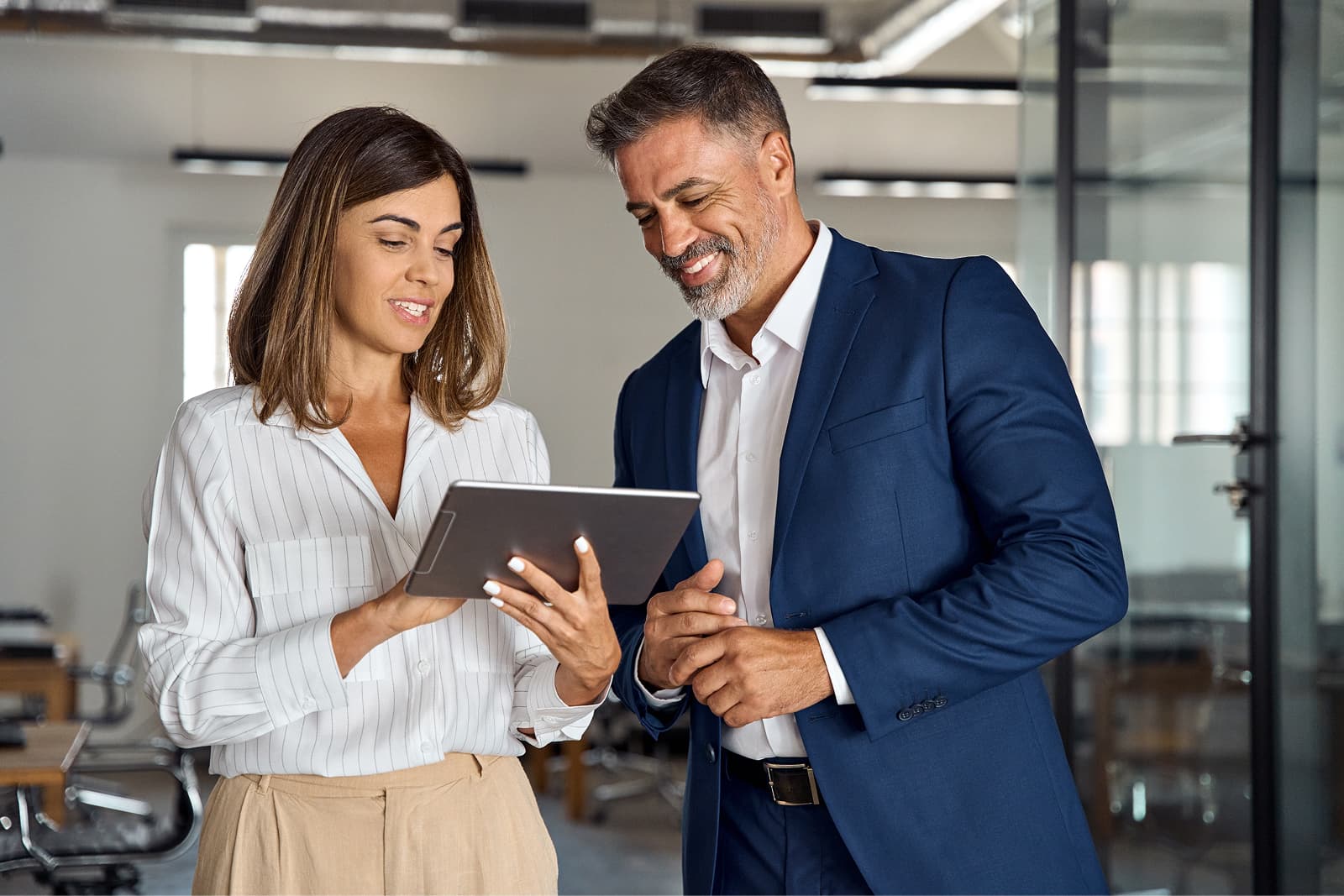 A man and a woman looking at a mobile tablet