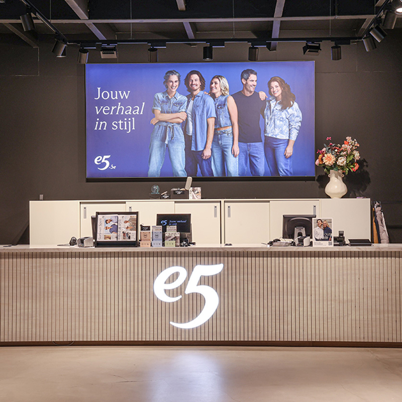 e5 store checkout counter with digital screen and logo